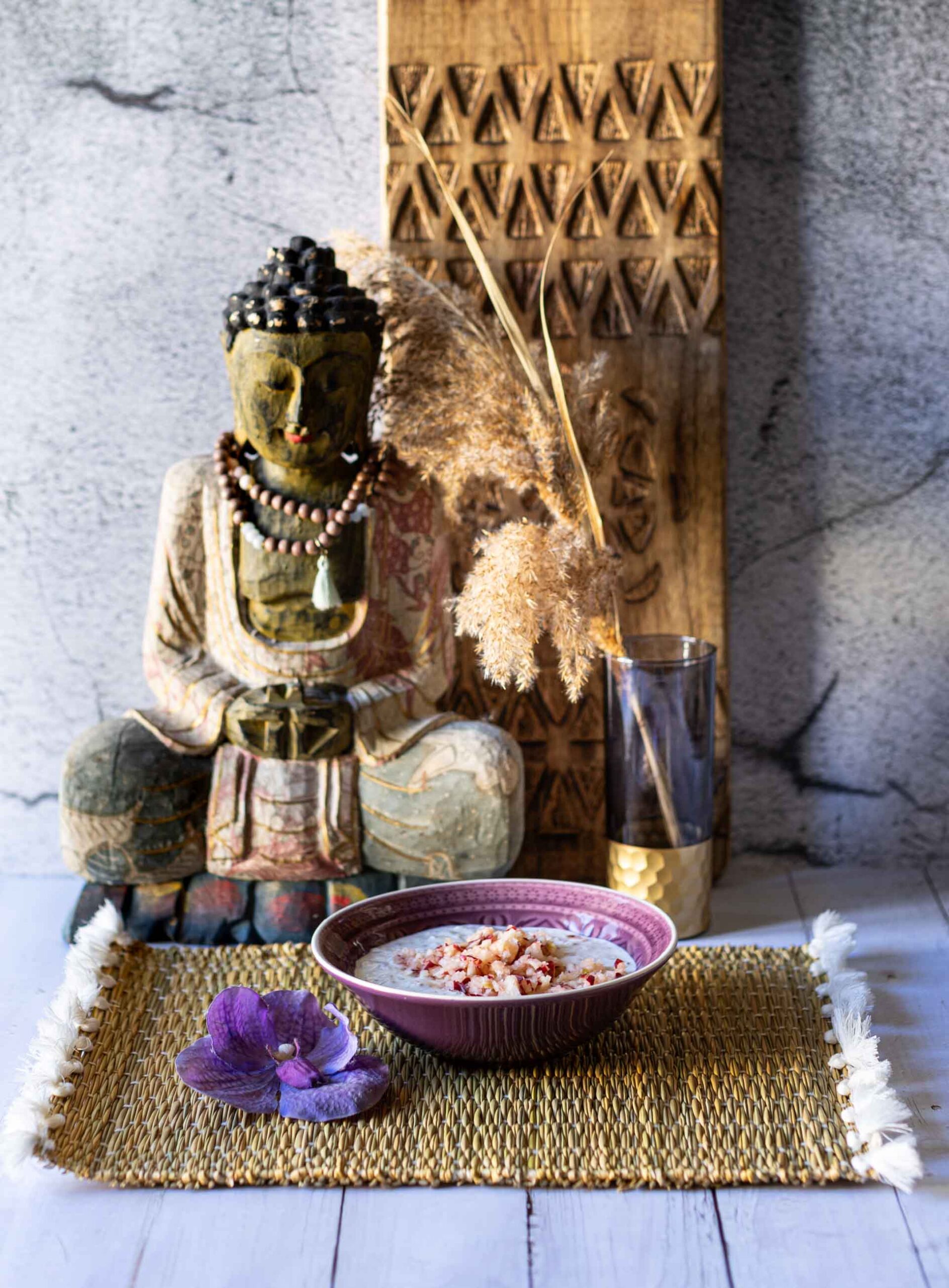 Overnight Oats im Bircher-Müsli Style in Schale vor Buddha-Deko.